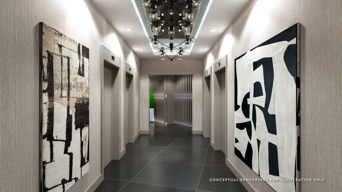 Zona de cuatro elevadores con cuadros modernos y luces blancas