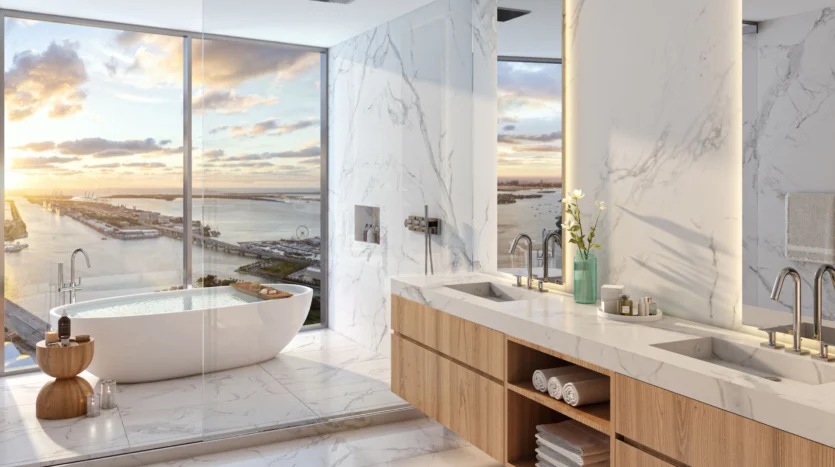 Baño elegante con dos lavamanos y vistas al mar