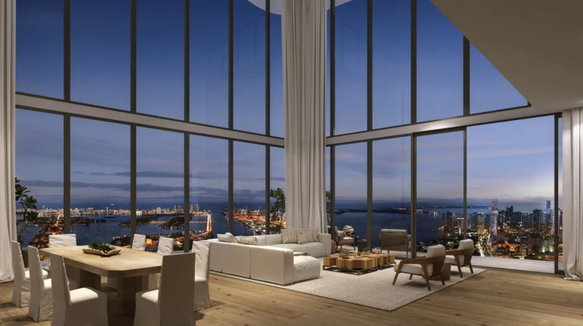 Sala de estar con muebles modernos y balcón con vistas al mar de noche