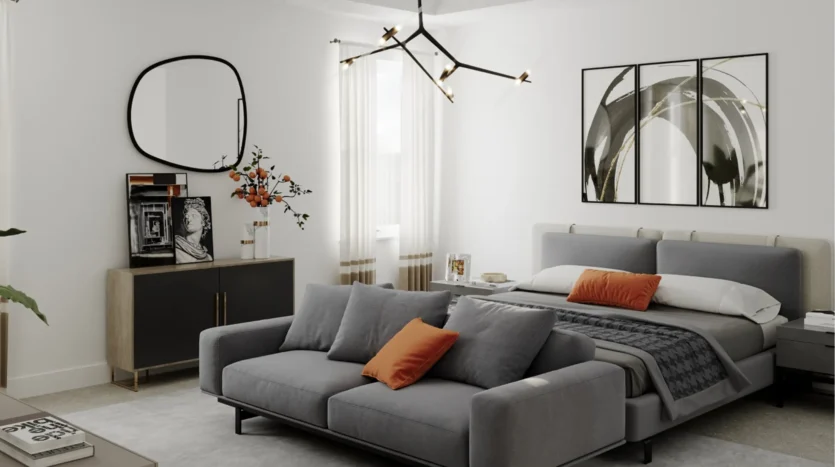 Dormitorio de una cama con sofá, cuadro moderno y espejo