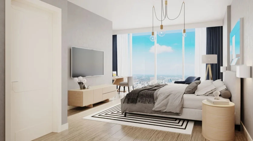 Dormitorio de lujo con una cama, televisor y vistas al mar