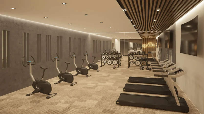 Gimnasio moderno con detalles dorados y máquinas de cardio